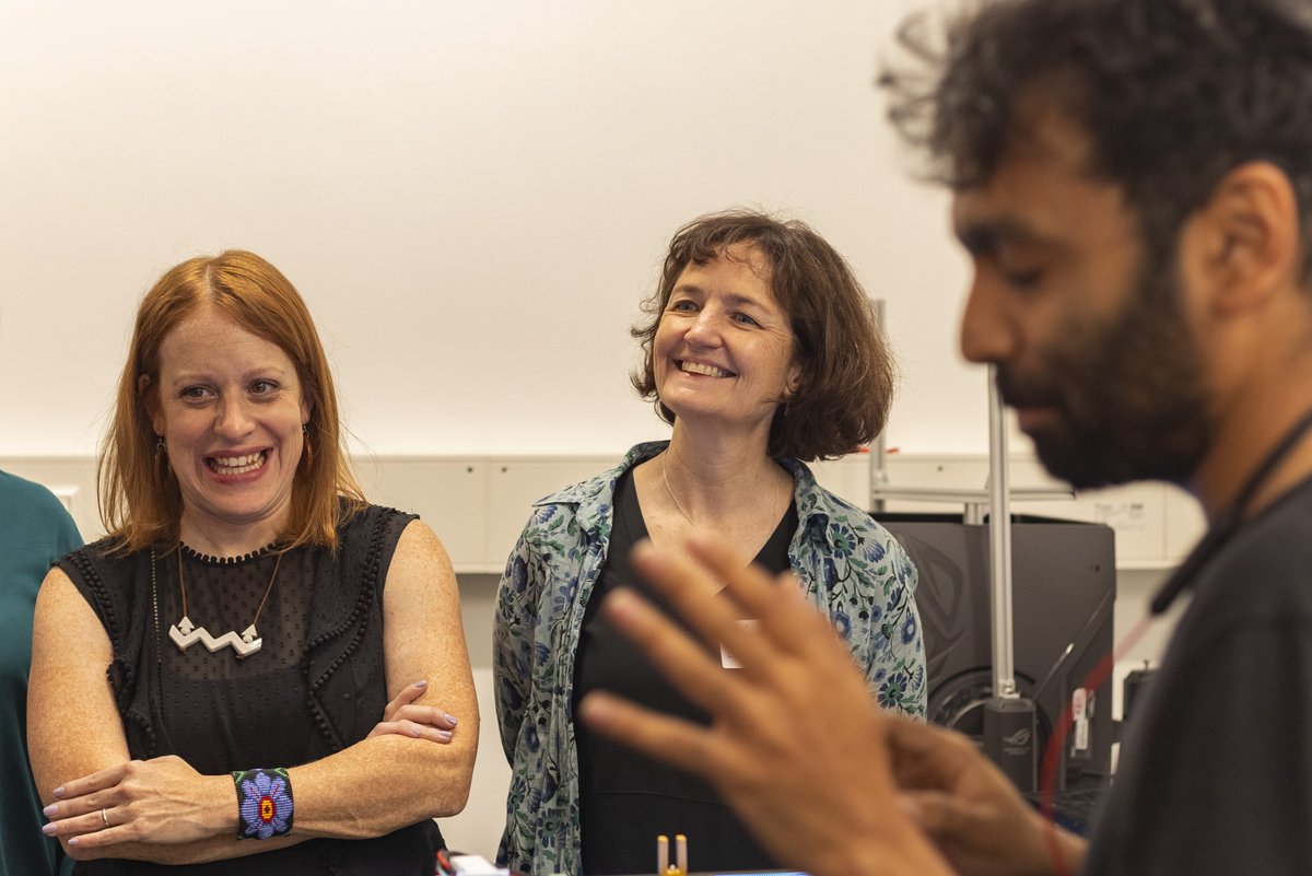 Two women laughing and smiling about something that was said.