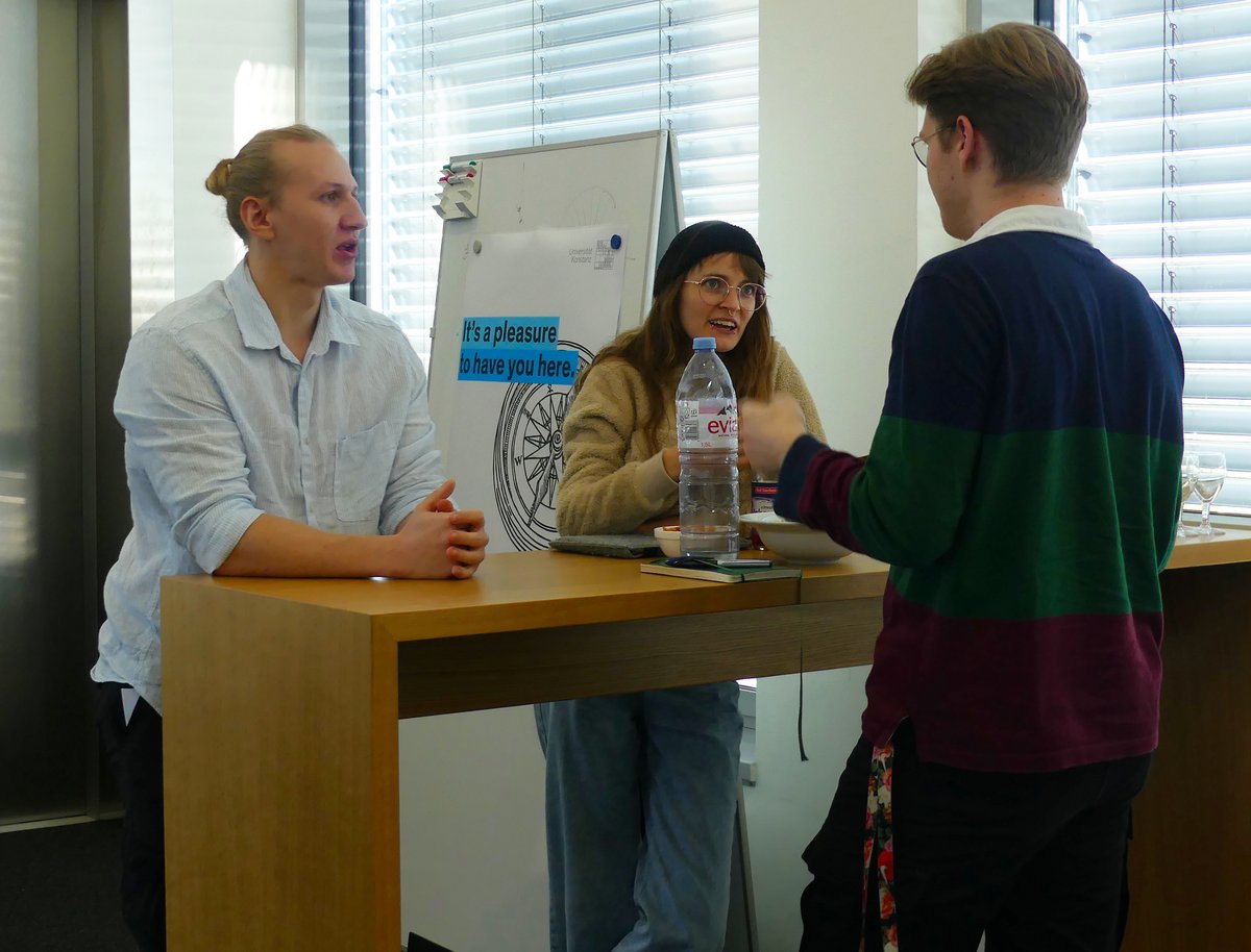 Three person standing at a table